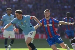 Wharton (right) duelling for the ball with Manchester City's Kevin De Bruyne